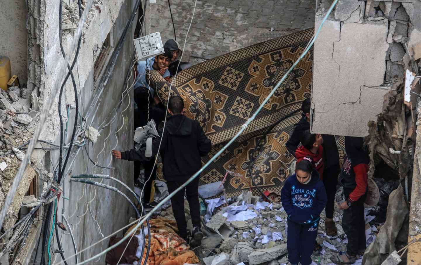 Palestinians residents examines the rubbles of destroyed and damaged buildings following Israeli attacks in Rafah, Gaza on February 16, 2024.