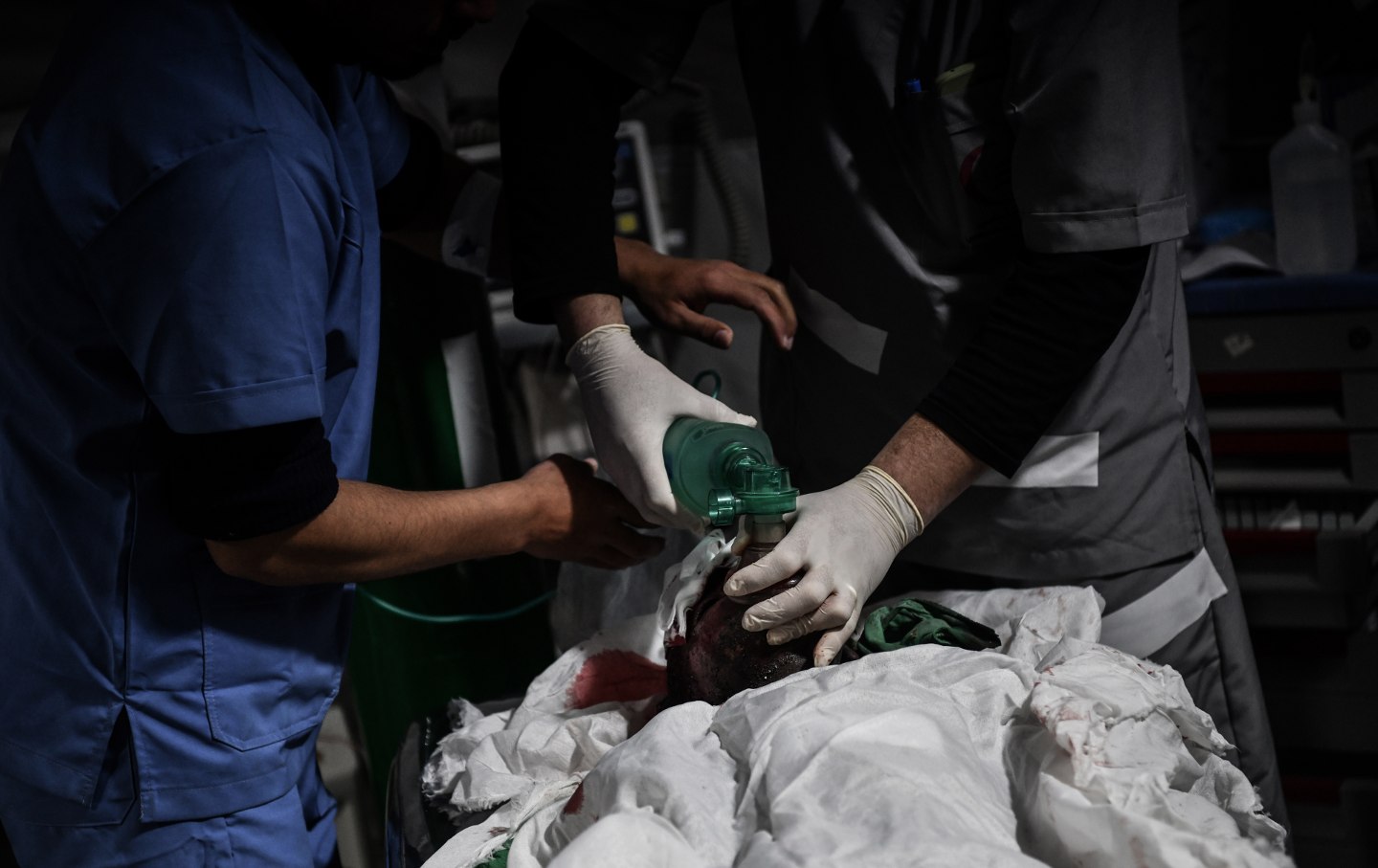An injured man pulled from the rubble of a collapsed building receives medical treatment after an Israeli air strike hit a residential building in Rafah on February 26, 2024.