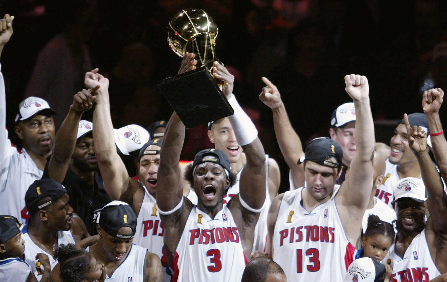 Ben Wallace, #3 of the Detroit Pistons, holds up the Larry O'Brien NBA Championship trophy as he celebrates with teammates after defeating the Los Angeles Lakers 100-87 in game five of the 2004 NBA Finals on June 15, 2004.