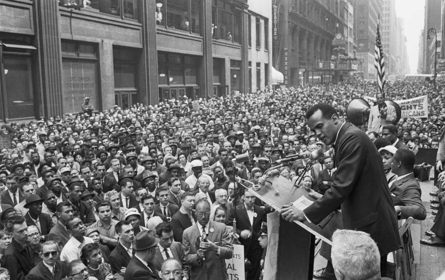 Harry Belafonte sings before a crowd at a civil rights rally.