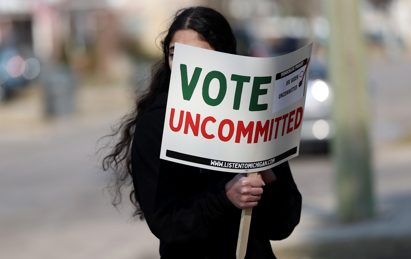 A Democratic voter uncommitted to President Joe Biden rallies outside of a polling station in Dearborn, Mich., on February 27, 2024.