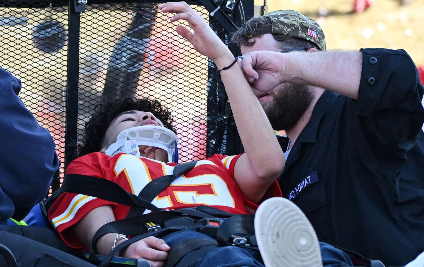 An injured person is aided near the Kansas City Chiefs' Super Bowl LVIII victory parade on February 14, 2024, in Kansas City, Mo.