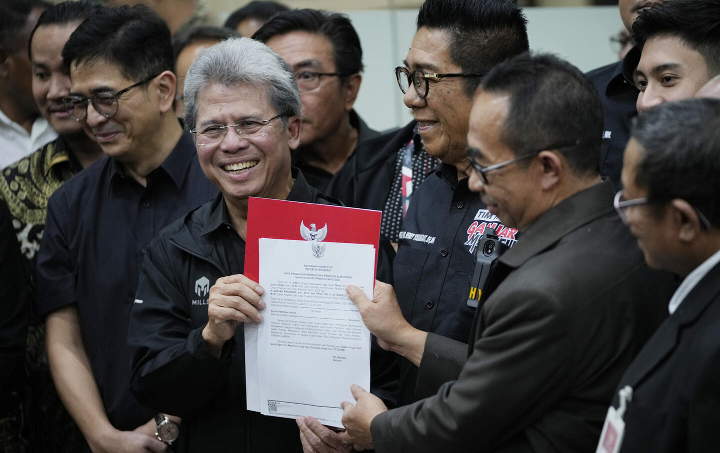 Todung Mulya Lubis, left, a prominent Indonesian lawyer representing losing presidential candidate Ganjar Pranowo, registers a legal challenge alleging widespread irregularities and fraud in the February 14 presidential election, at the Constitutional Court in Jakarta, Indonesia, Saturday, March 23, 2024.