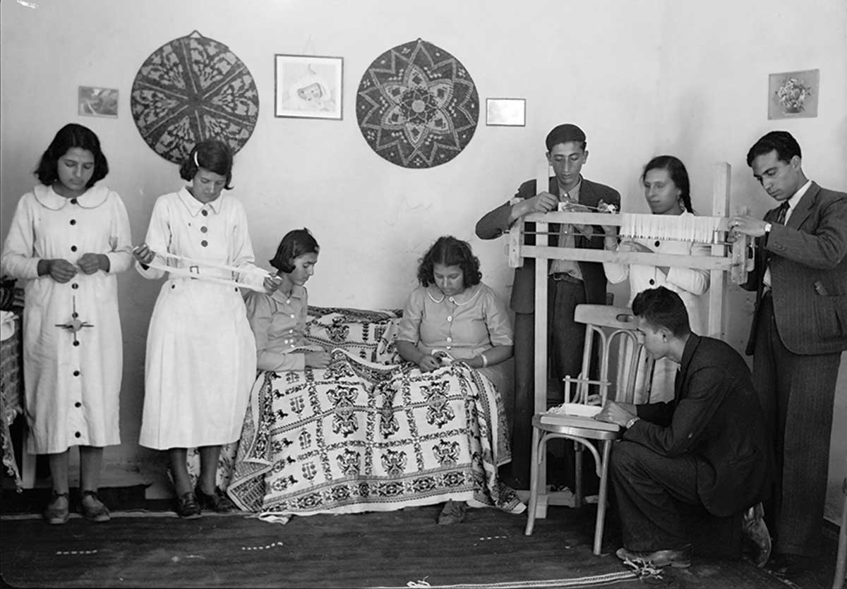Young women and men working in the Arab Women’s Union workshop in Ramallah, circa 1934–39.