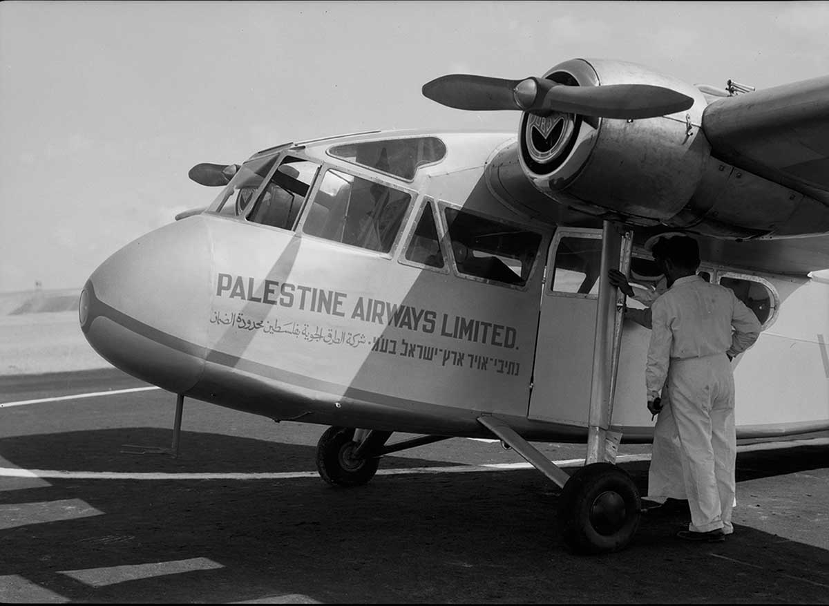 A Palestine Airways airplane, with its branding in three languages, at the opening of the Lydda airport runway, September 22, 1938.