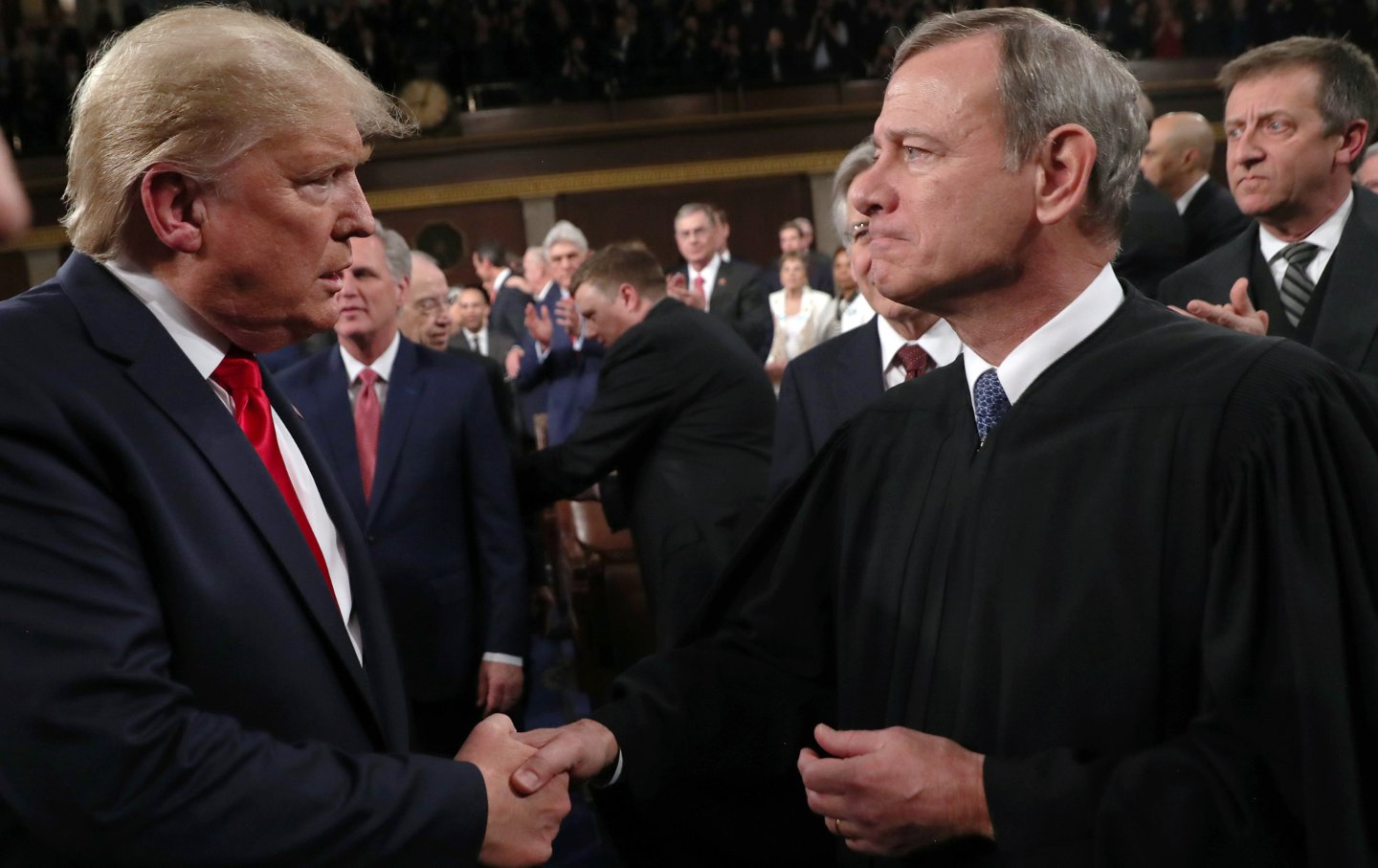 President Donald Trump shakes hands with Supreme Court Chief Justice John Roberts before the State of the Union address in the House chamber on February 4, 2020, in Washington, D.C
