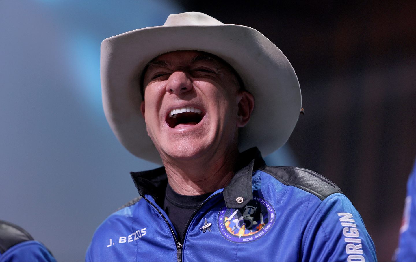 Jeff Bezos laughs as he speaks about his flight on Blue Origin’s New Shepard into space during a press conference on July 20, 2021 in Van Horn, Texas.