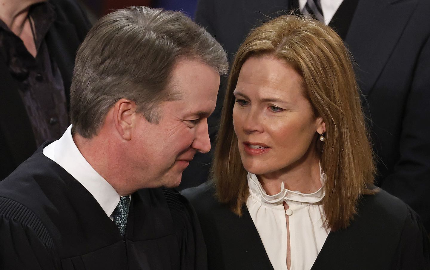 Supreme Court Associate Justices Brett Kavanaugh and Amy Coney Barrett talk before President Joe Biden's State of the Union address in February 2023.