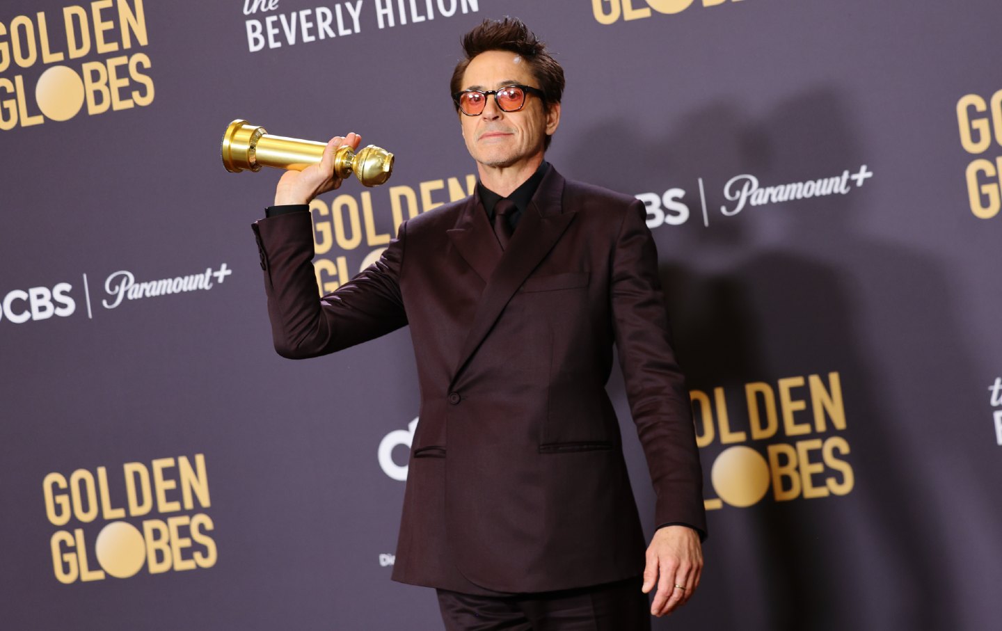 Robert Downey Jr. poses with his Golden Globe for Best Performance by a Male Actor in a Supporting Role
