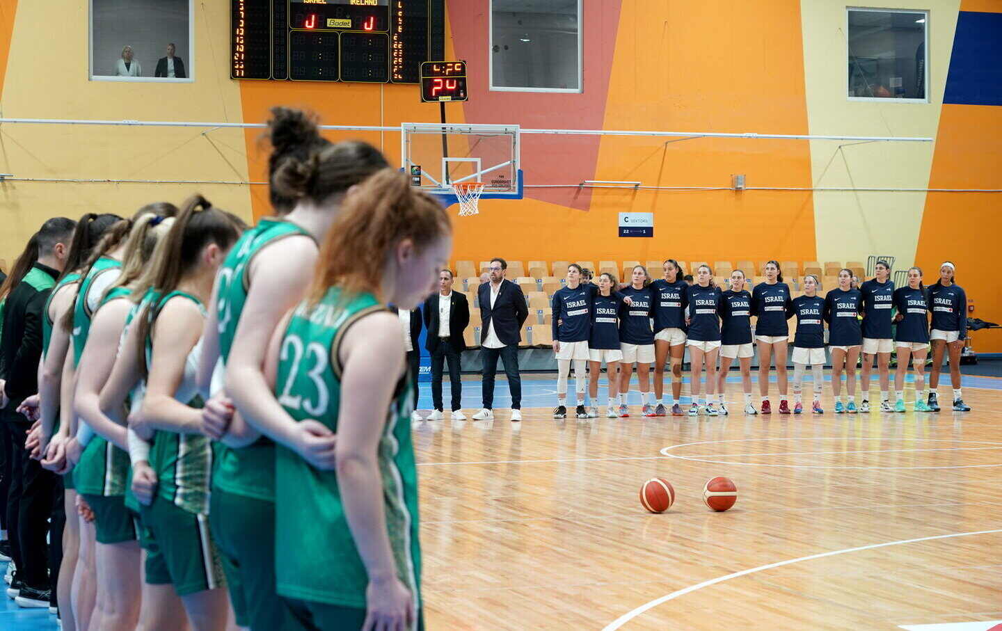 The Ireland team stand by their bench as the Israel team stand on the court as the teams stand for their national anthems before the FIBA Women's EuroBasket Championship Qualifier match between Israel and Ireland at the Rimi Olympic Centre in Riga, Latvia.