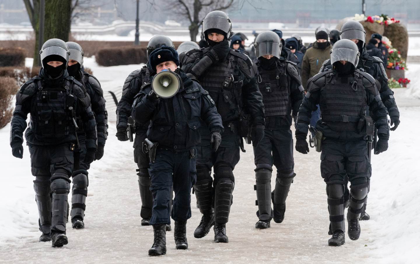 Police block the way to a monument in St. Petersburg, Russia, honoring the memory of Russian opposition leader Alexei Navalny the day after news of his death.