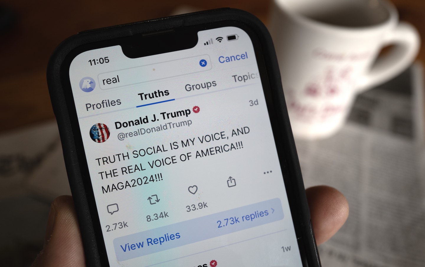 Donald Trump's social media platform Truth Social is shown on a cell phone.