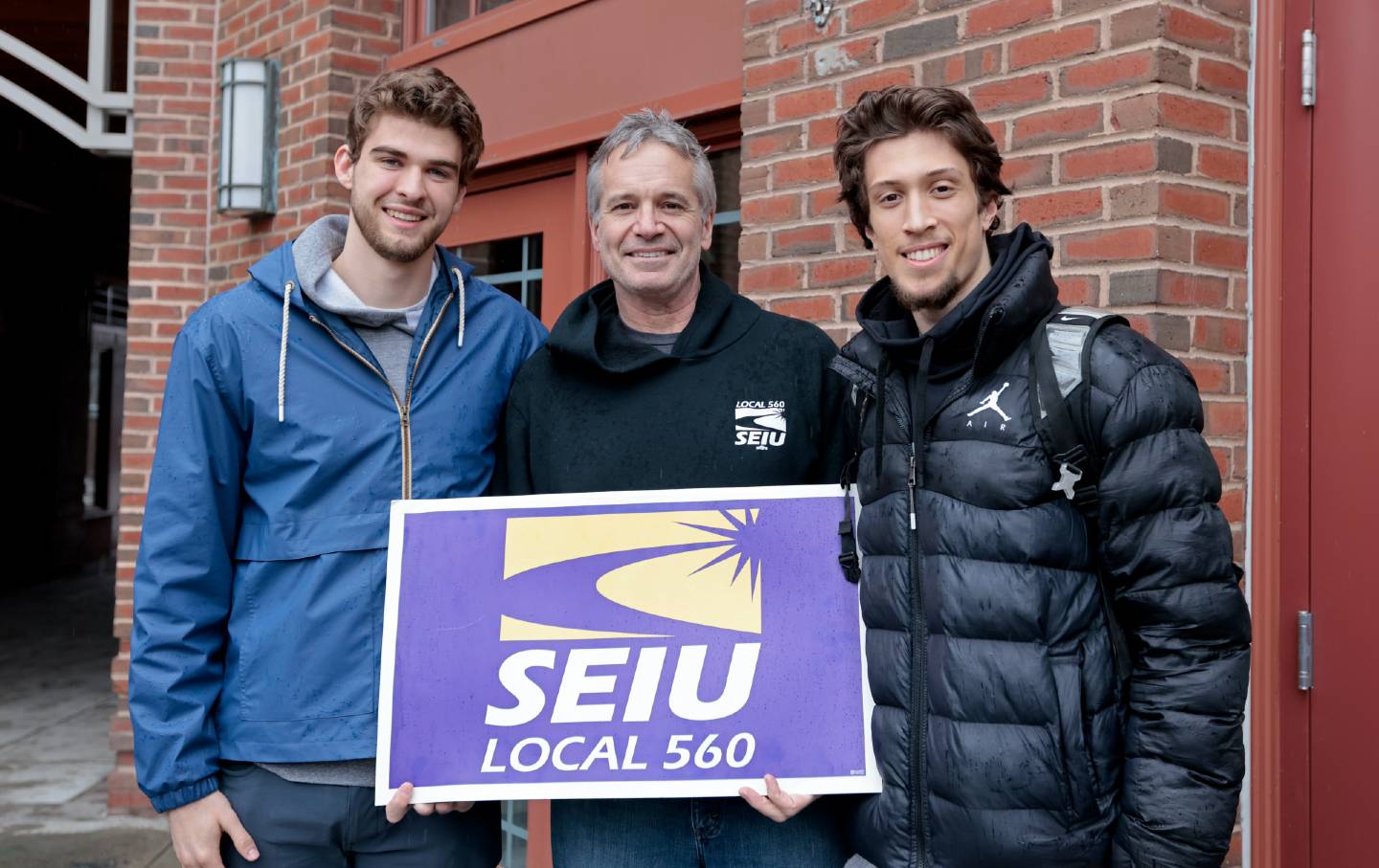 Dartmouth player organizers with an SEIU Local 560 sign