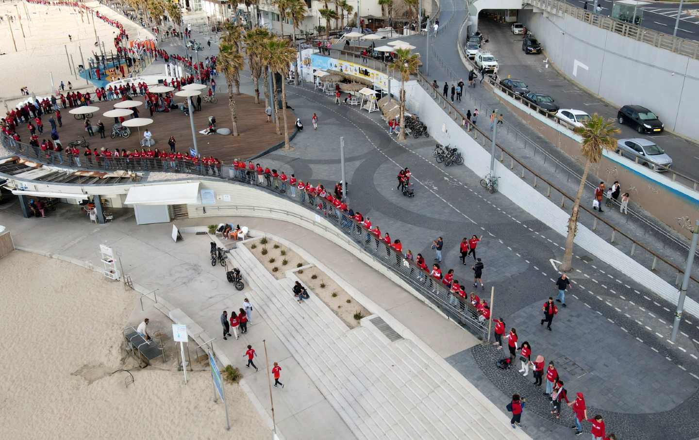 In this aerial view, protesters supporting women's rights are dressed in red as they form a human chain on International Women's Day in Tel Aviv on March 8, 2023.