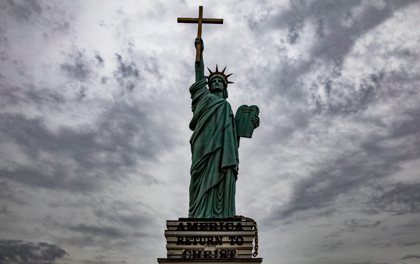 A statue modeled after the Statue of Liberty holds up a cross instead of a torch with “America Return to Christ” outside of World Overcomers Church in Memphis, Tenn., on January 7, 2018.
