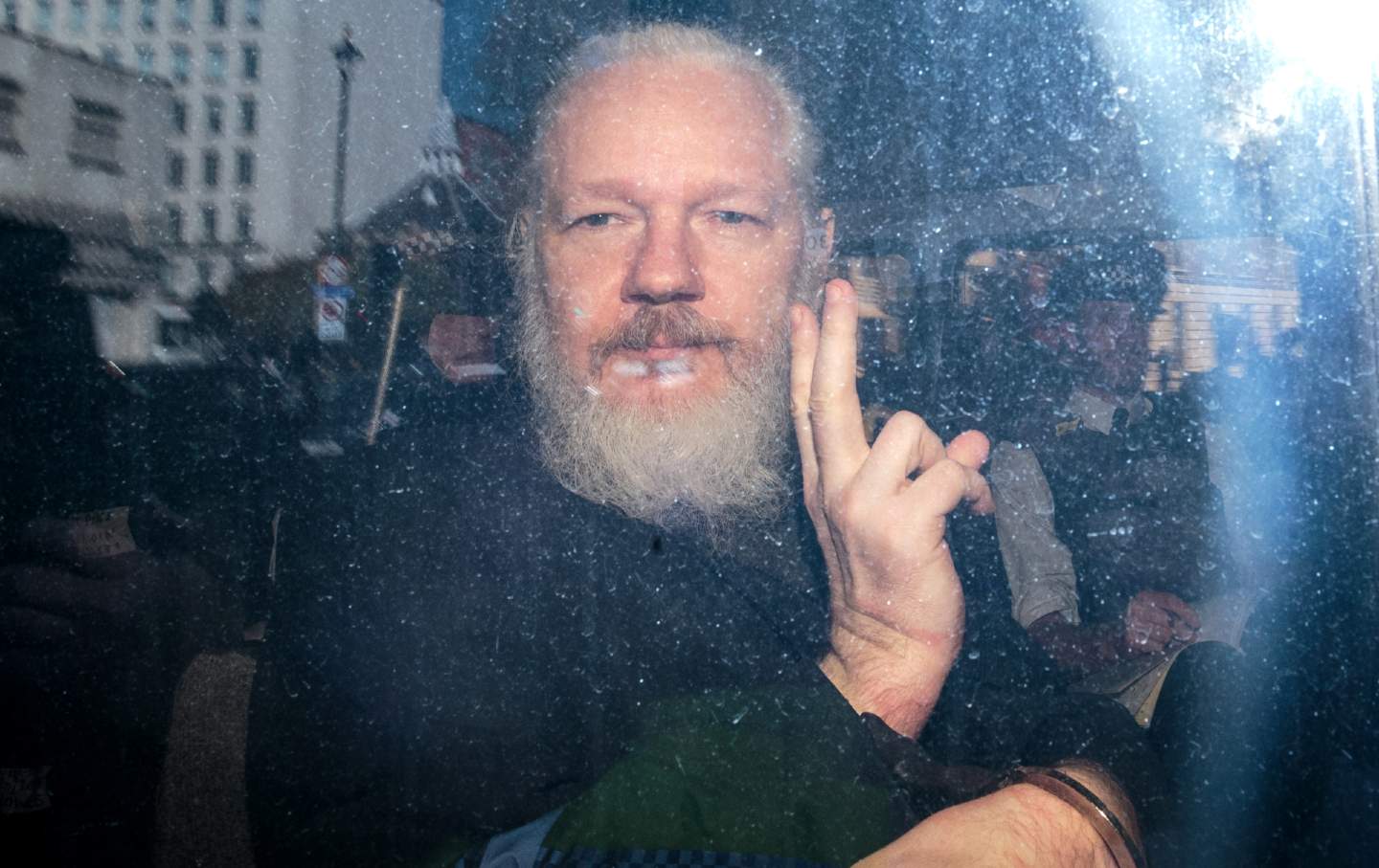 Julian Assange in police vehicle
