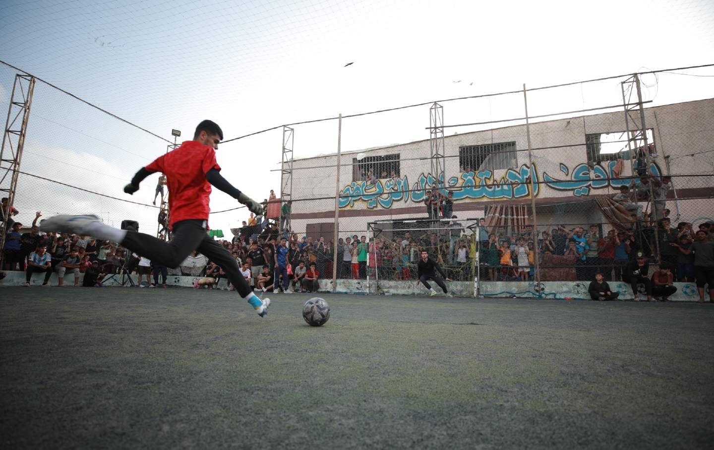 Taking a shot on goal during a soccer game in Rafah