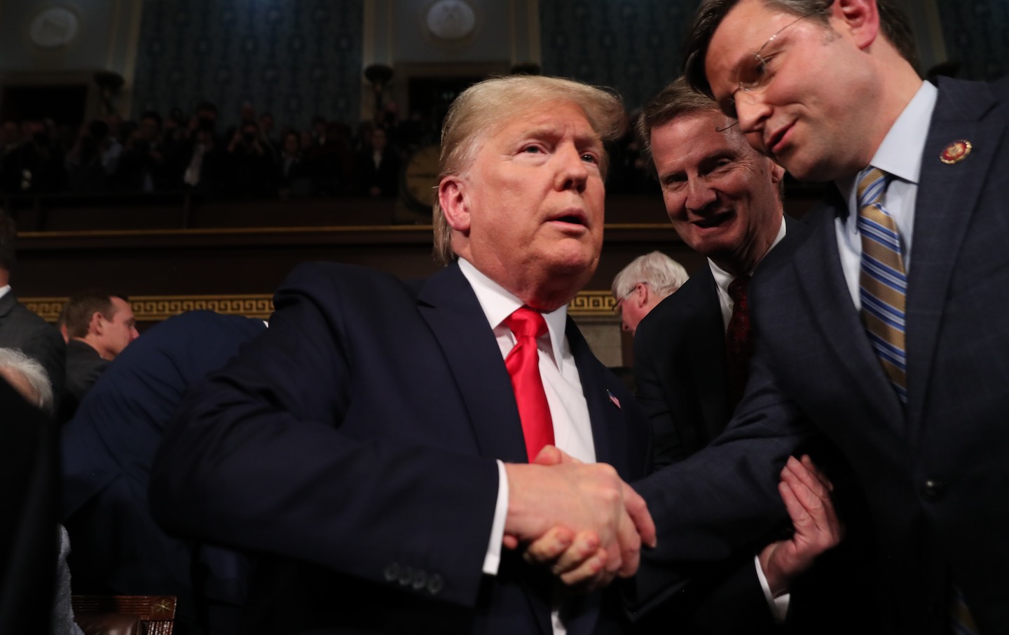 Donald Trump is greeted by Representative Mike Johnson (R-LA) before the 2020 State of the Union address in the House chamber on February 4, 2020, in Washington, DC.