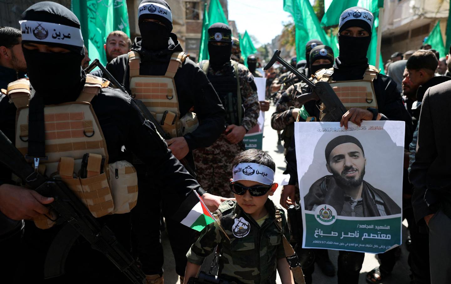 Young boy with Hamas militants 