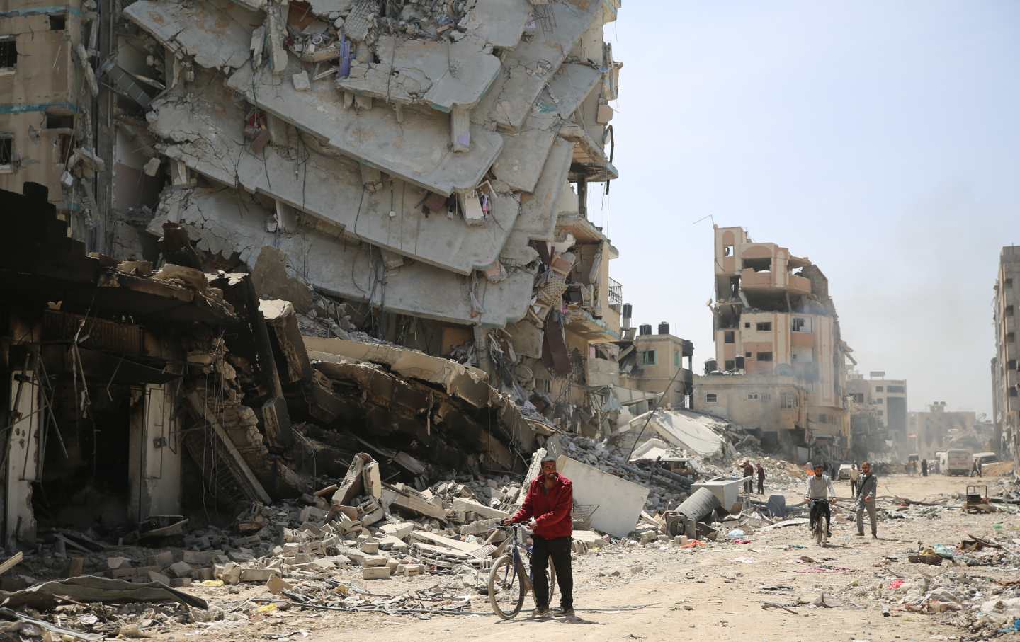 A man walks near the debris of damaged building as the area around the Al-Shifa Hospital is destroyed in Gaza City, Gaza on April 01, 2024.