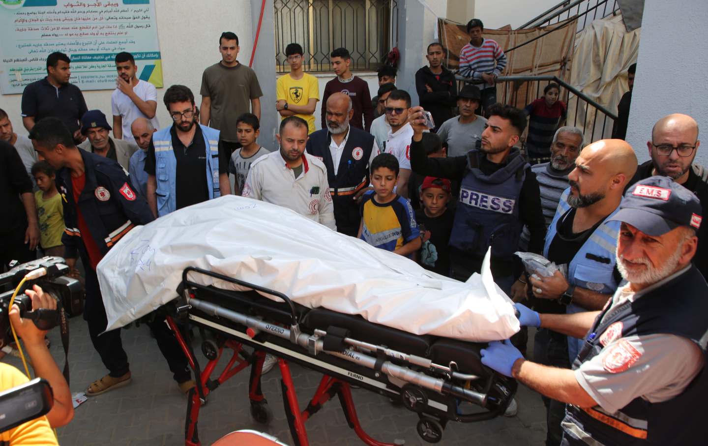 People prepare to transfer the body of a World Central Kitchen WCK worker killed by Israeli air strikes, near the Rafah border crossing, in the southern Gaza Strip, on April 3, 2024.