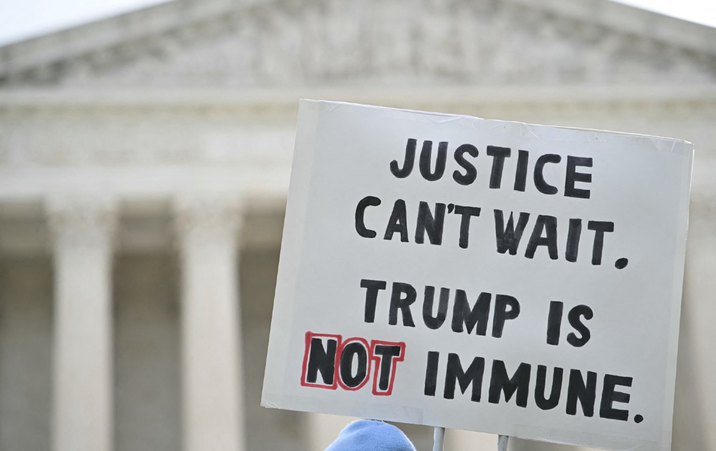 This image has an empty alt attribute; its file name is GettyImages-2149547437.jpg Protesters demonstrate outside the US Supreme Court Building as the justices prepares to hear arguments on the immunity of former US president Donald Trump.