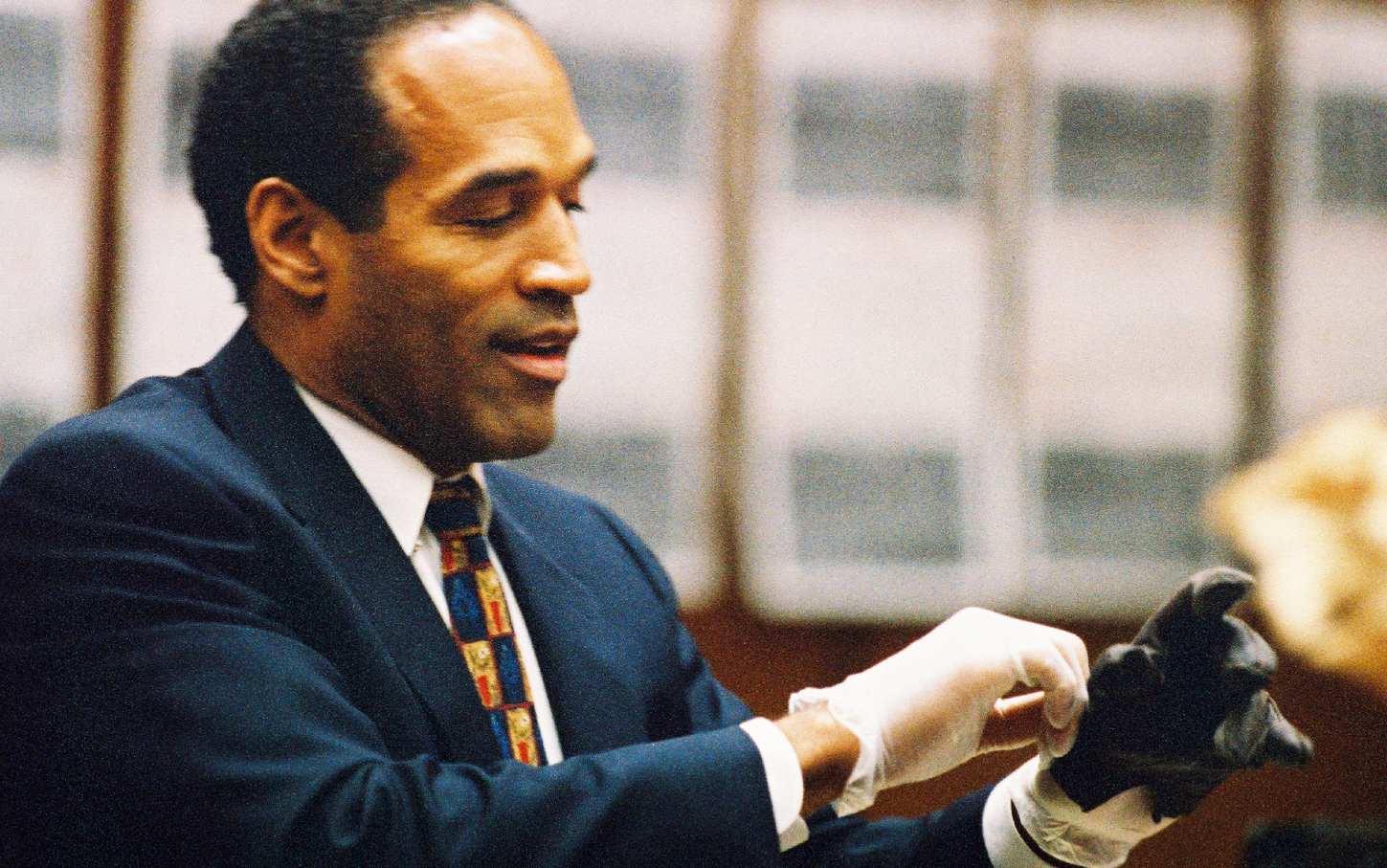O.J. Simpson tries on glove during trial