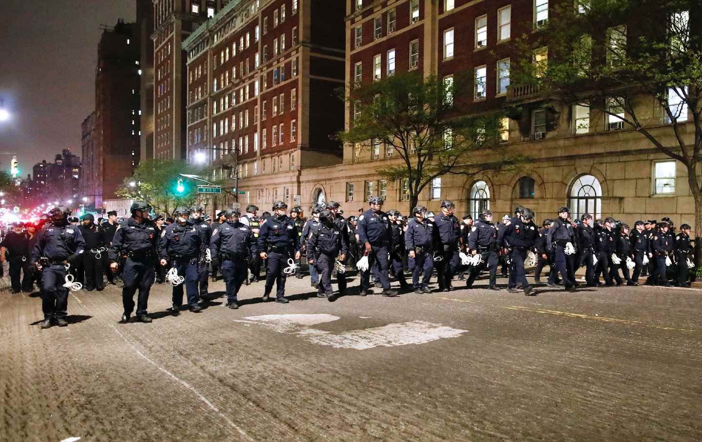NYPD officers in riot gear march onto Columbia University campus, where pro-Palestinian students are barricaded inside a building and have set up an encampment, in New York City on April 30, 2024.