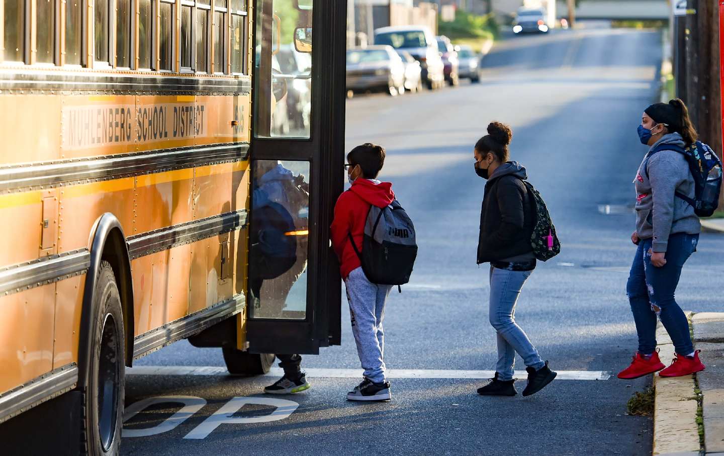 Young students get on a school bus in Muhlenberg Township, Pennsylvania, on October 20, 2021.