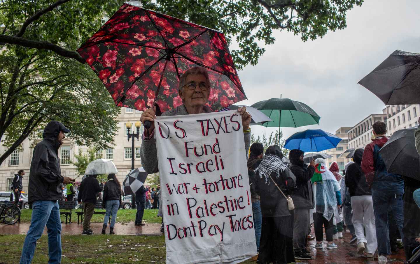 A demonstrator holds up a sign with 