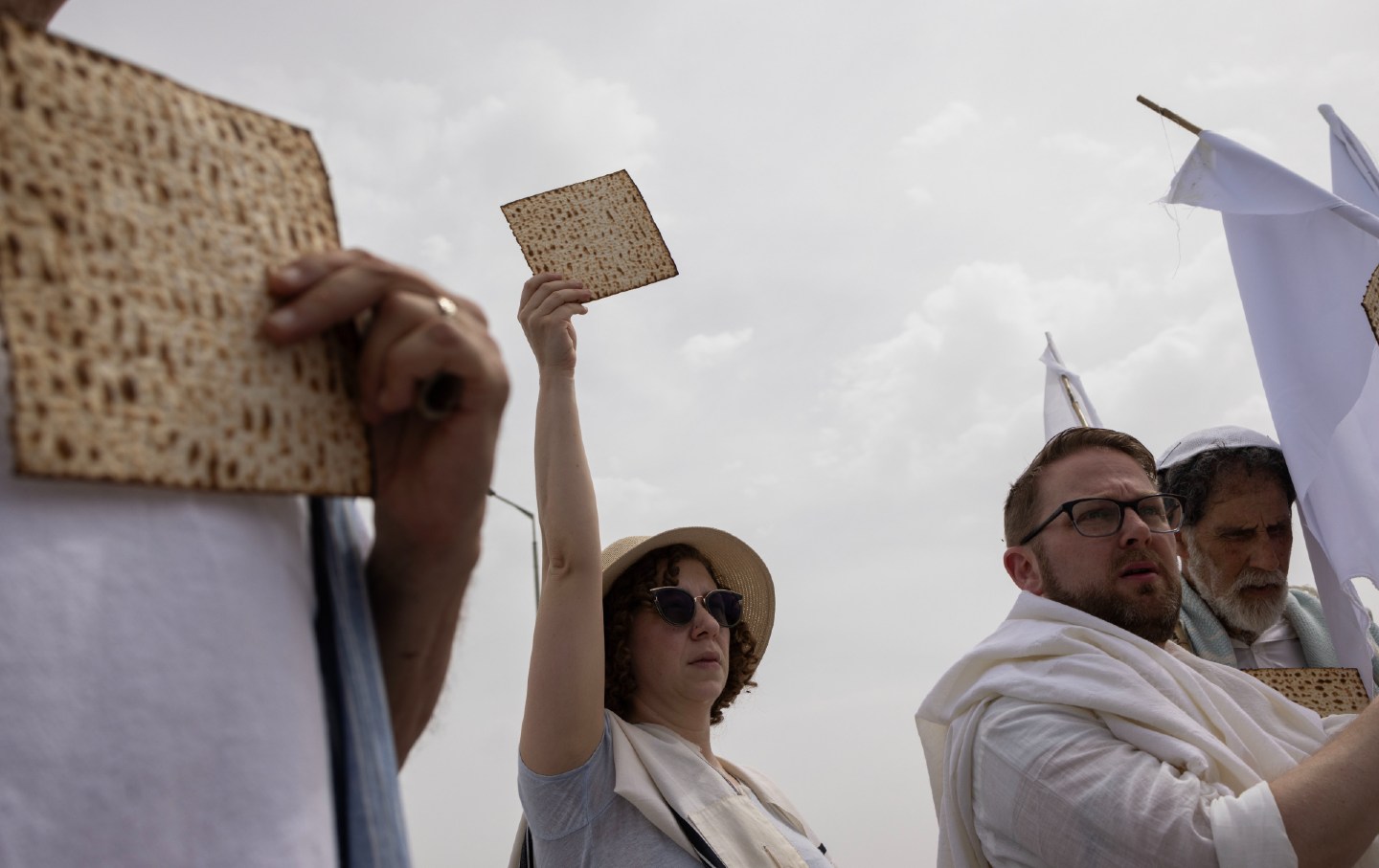 Activists with Rabbis for Ceasefire hold up pieces of matzah—symbols of Passover’s central imperative to “Let all who are hungry come and eat!”