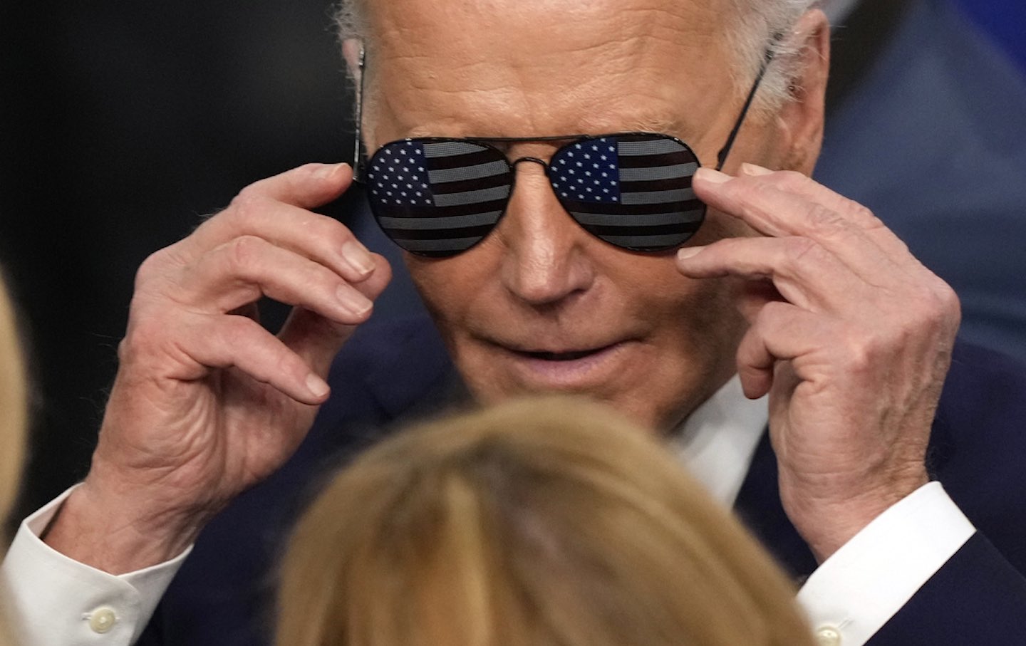 Joe Biden tries on a pair of sunglasses on in Nashua, New Hampshire.