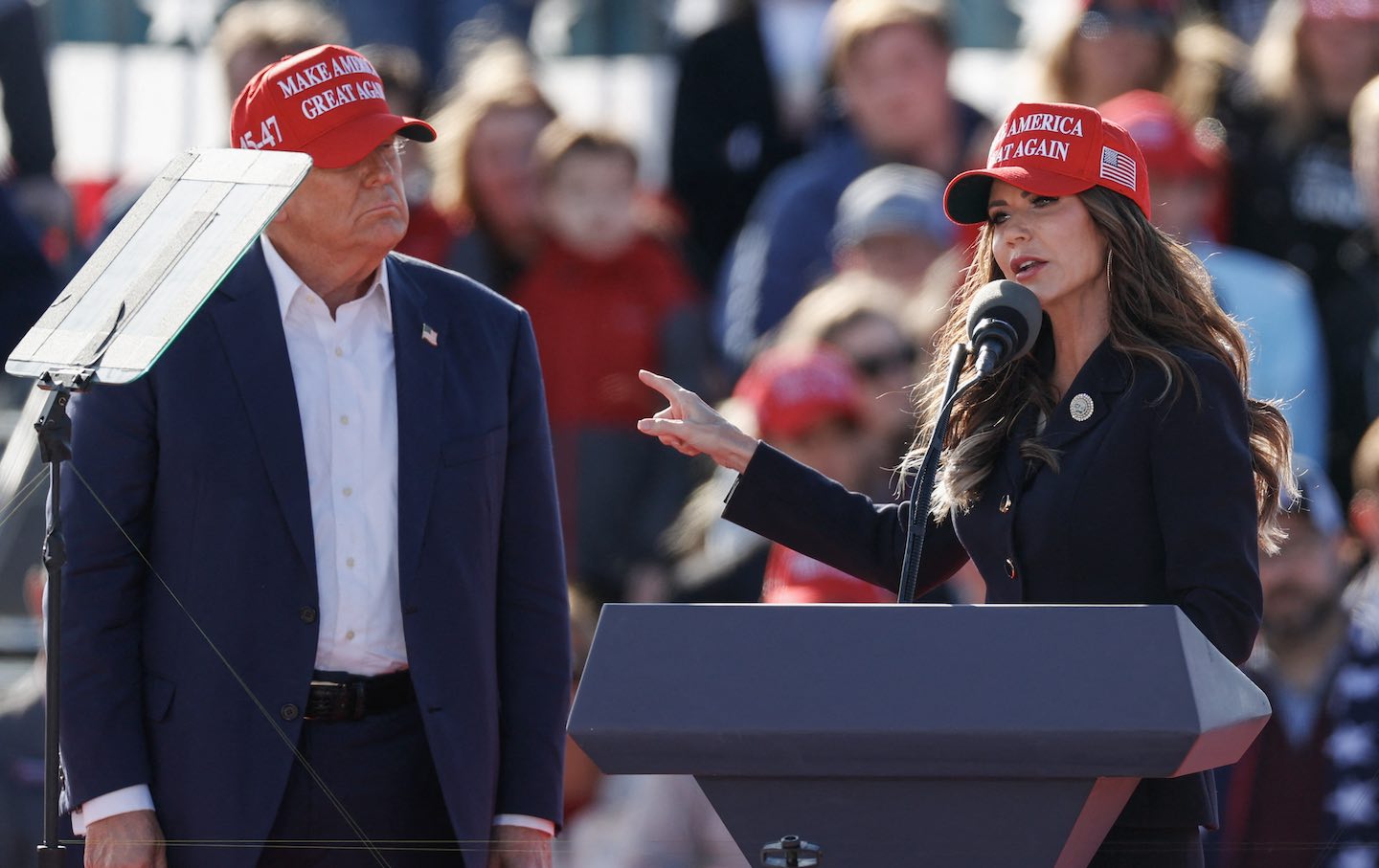Donald Trump listens as South Dakota Governor Kristi Noem speaks during a Buckeye Values PAC Rally in Vandalia, Ohio, on March 16, 2024.