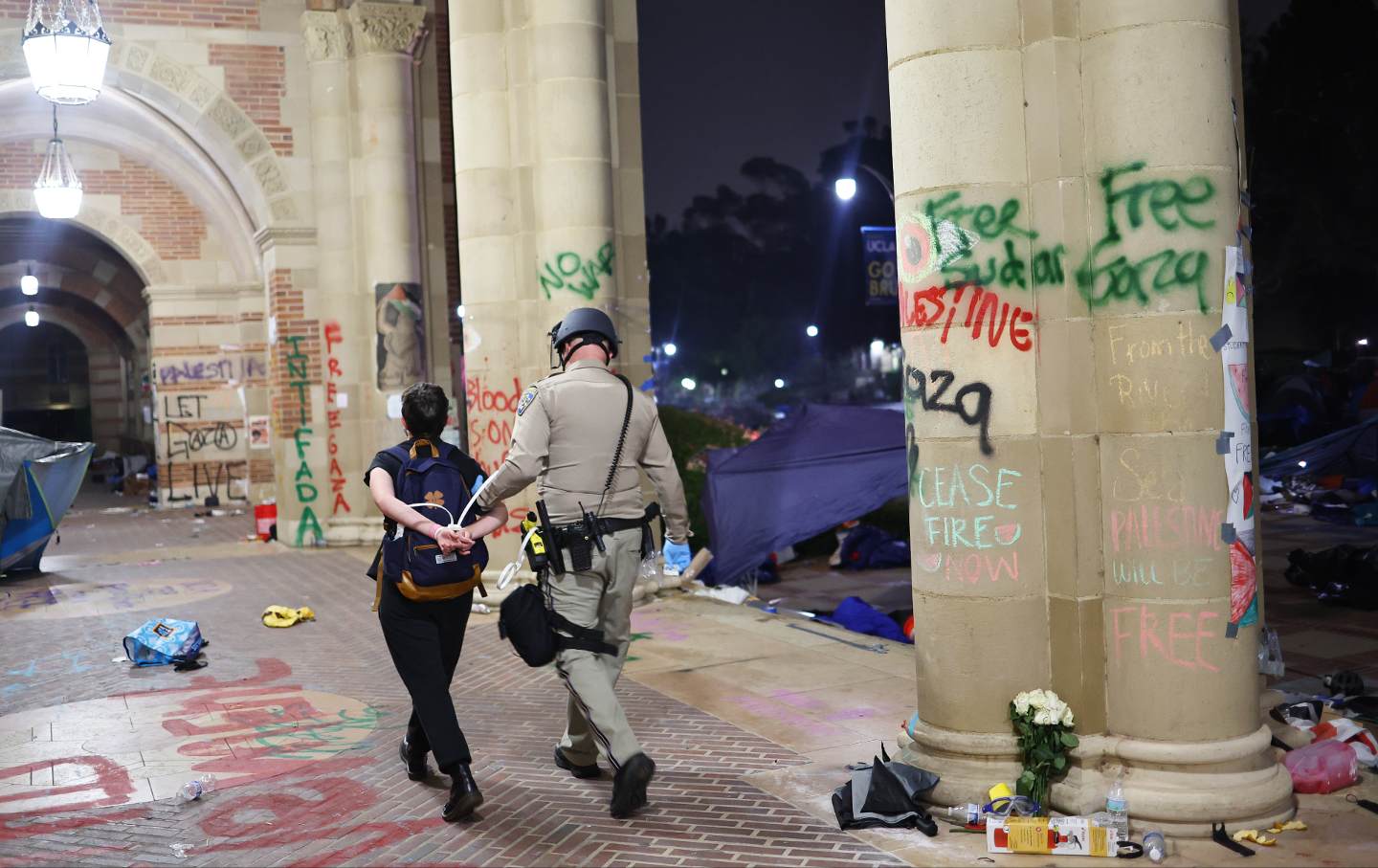 A California Highway Patrol officer detains a protester at UCLA on May 2, 2024.