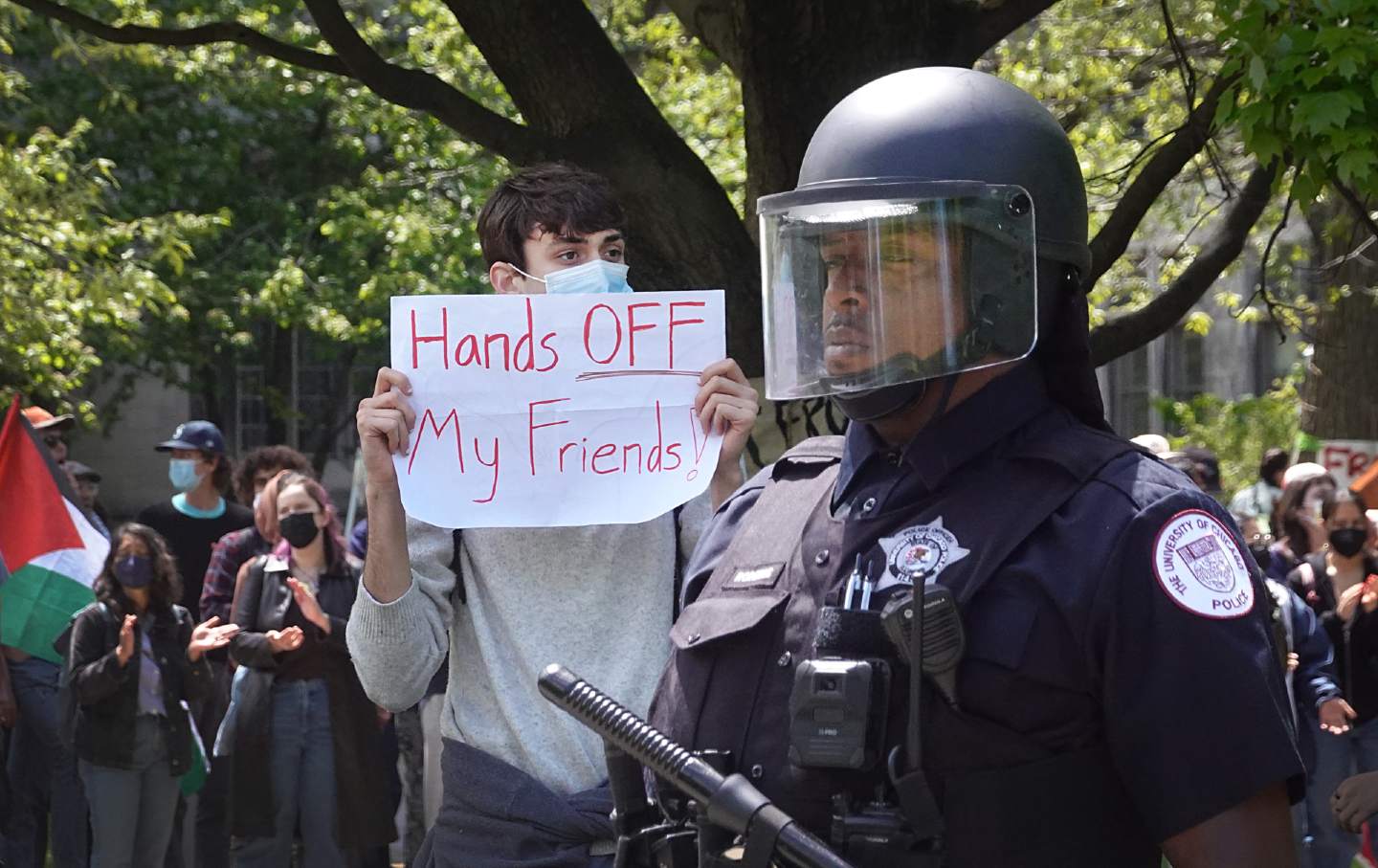 A campus police officer stand stands at the ready as protesters demonstrate at the University of Chicago on May 3, 2024.