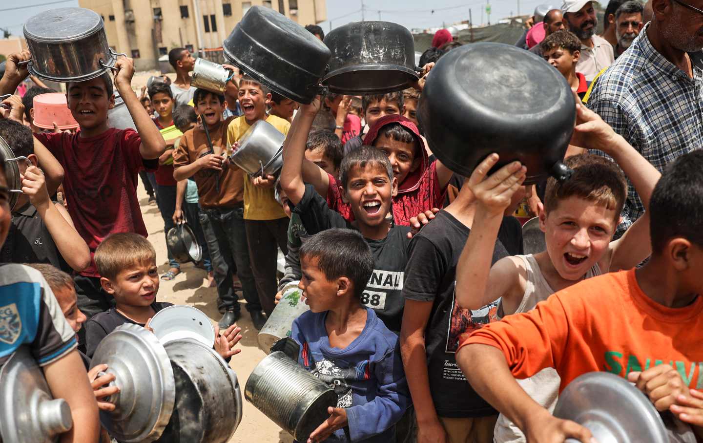 Displaced Palestinian children line up to receive food in Rafah, on the southern Gaza Strip, on May 19, 2024.