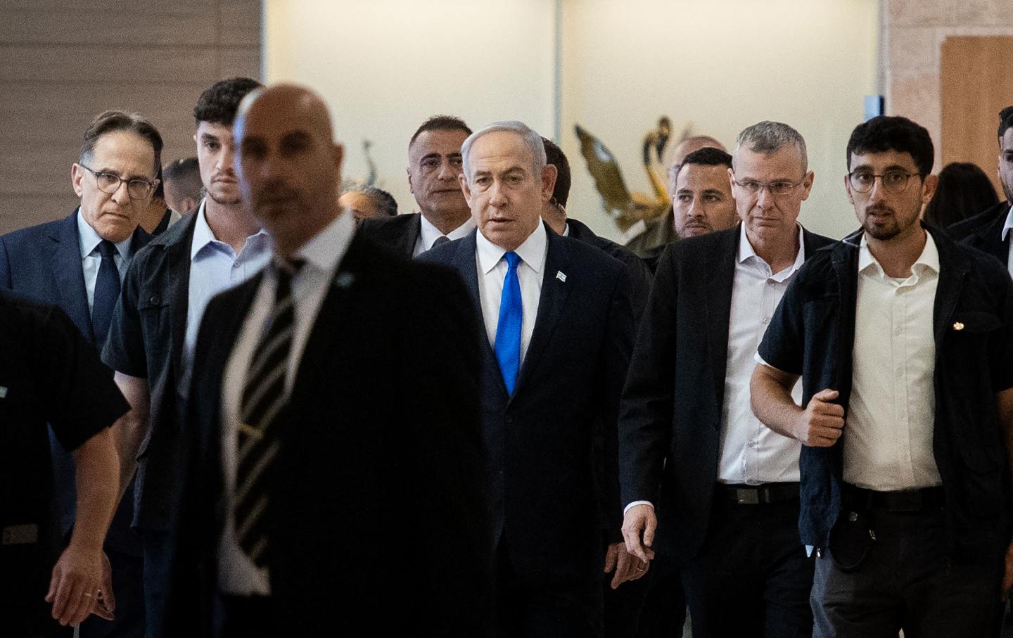 Israeli Prime Minister Benjamin Netanyahu (C) arrives for a party meeting at the Israeli parliament, the Knesset, in Jerusalem on May 20, 2024. Israel on May 20 slammed as a 