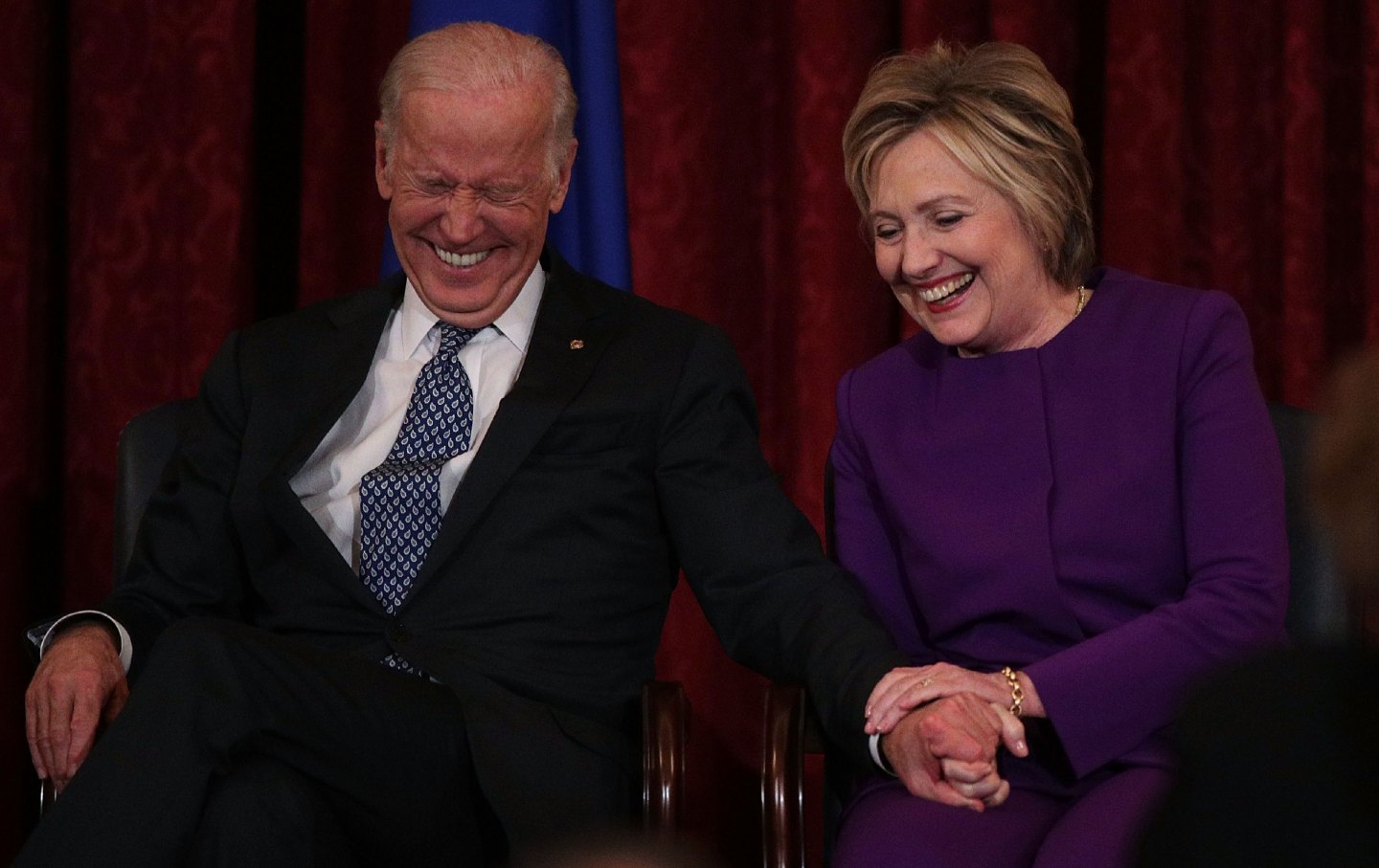 Former US secretary of state Hillary Clinton shares a moment with then–Vice President Joe Biden during a portrait unveiling ceremony for then–Senate minority leader Senator Harry Reid on December 8, 2016.