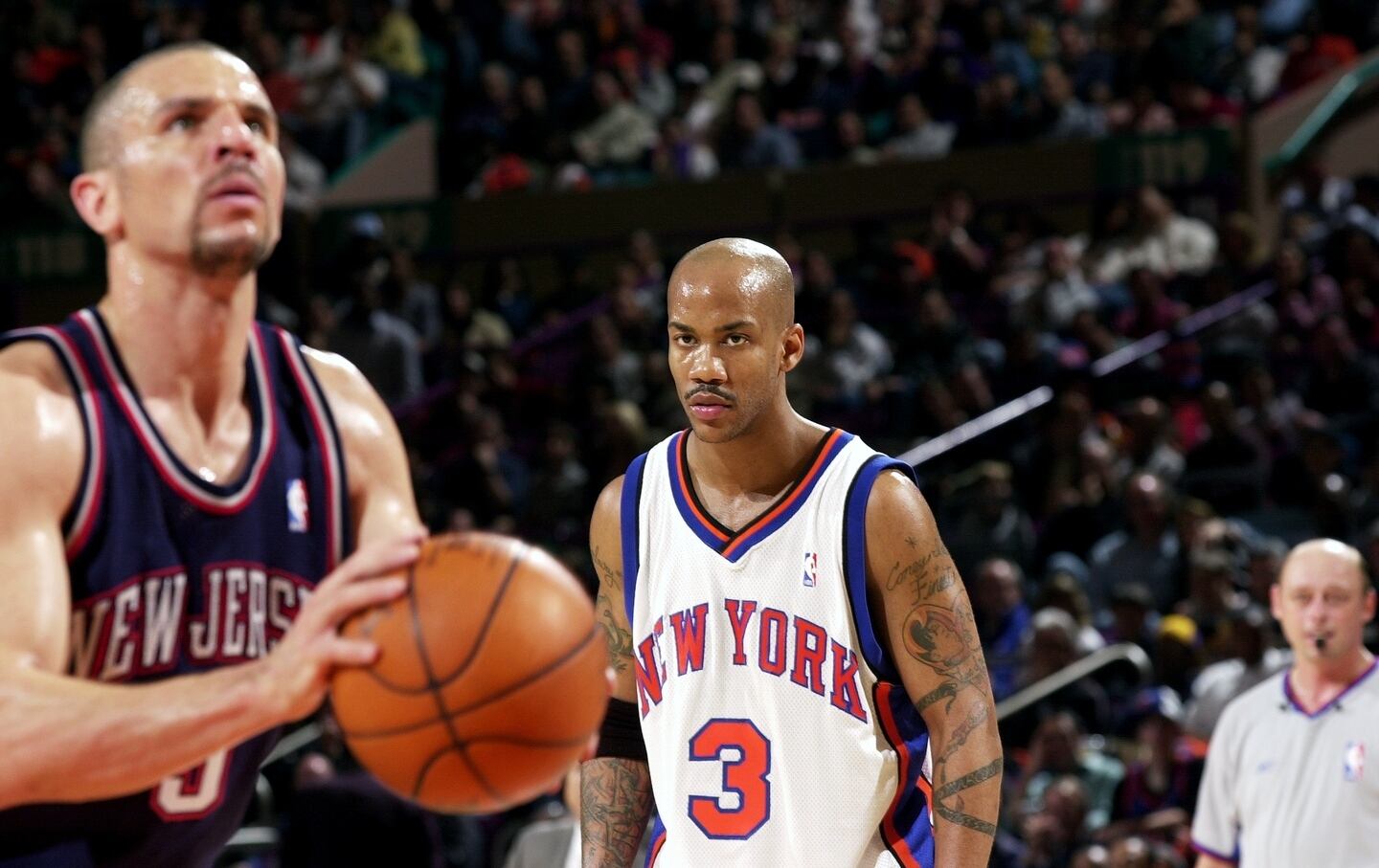 The New York Knicks' Stephon Marbury watches as the New Jersey Nets' Jason Kidd shoots a free throw in the second half of Game 4 of first-round playoffs at Madison Square Garden.