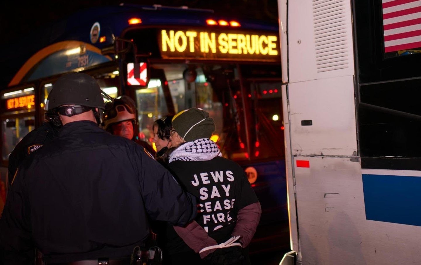 NYPD officers load protesters calling for a cease-fire in Gaza onto MTA buses on April 23, 2024.