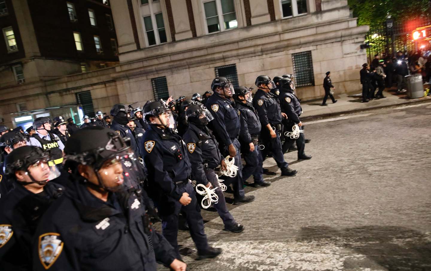 A large crowd of NYPD officers in riot gear on the Columbia campus.