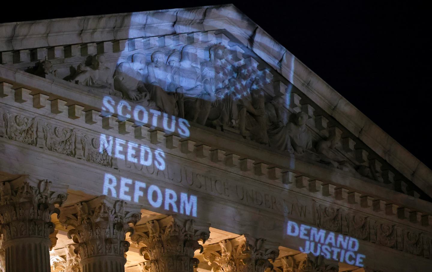 Demand Justice projects the “Stop the Steal” upside-down American flag on the US Supreme Court Building on May 21, 2024, to call attention to Justice Alito’s actions in Washington, DC.