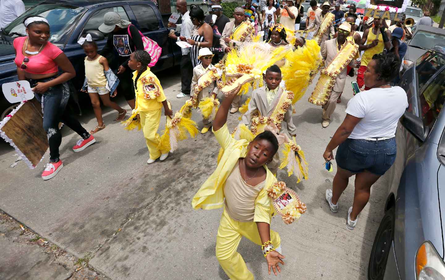 Members of the Original Big Seven Social Aid & Pleasure Club march in the 7th Ward on June 1, 2013, in New Orleans, Louisiana. The second line parade was rescheduled after 19 people were shot and one more injured fleeing the scene on Mother's Day.