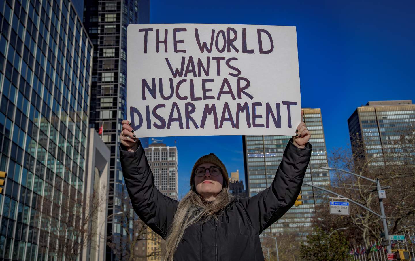 A protester holds a sign at a vigil outside the United States Mission to the United Nations in New York City on November 30, 2023, calling on the US to be the first nuclear-armed state to sign the Nuclear Weapons Ban Treaty.