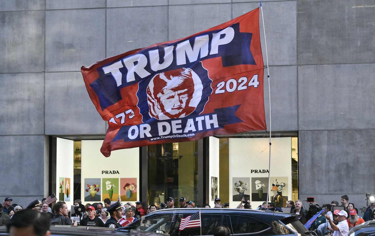 A Trump-themed flag is flown by supporters across the street from Trump Tower in New York City on May 31, 2024, before former US President and Republican presidential candidate Donald Trump holds a press conference following his felony conviction for falsifying business records.