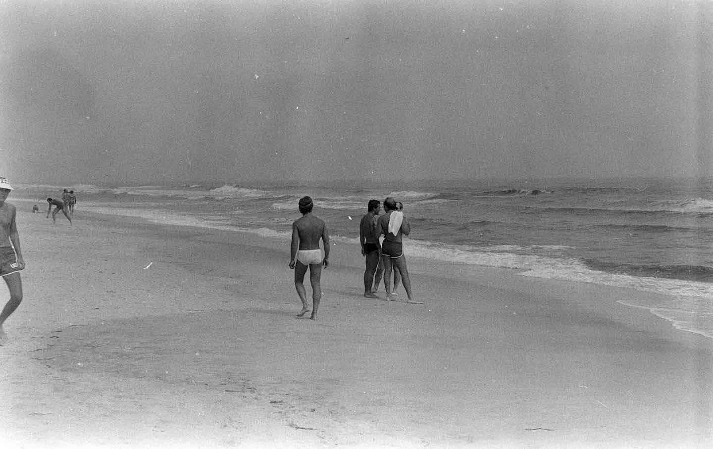 Guests walk along the beach near the Botel pool on Fire Island in Long Island, New York, 1976.