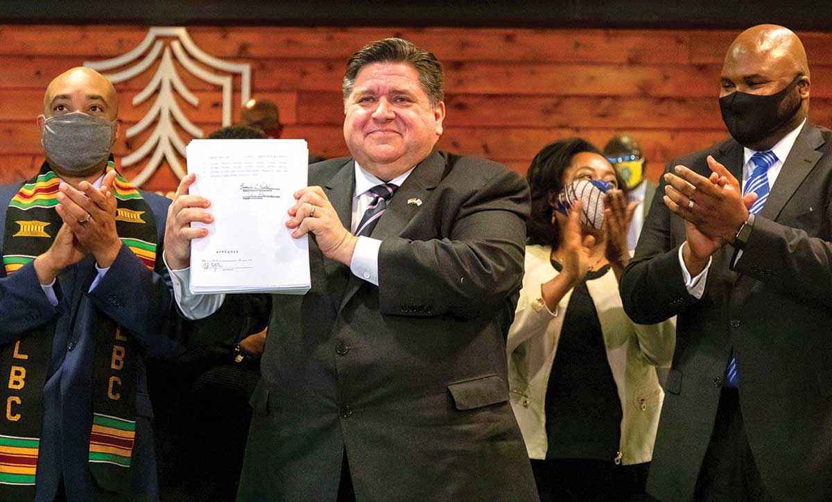 State Senator Robert Peters (second from left), the main sponsor of the Pretrial Fairness Act, celebrates the end of money bond in Illinois.