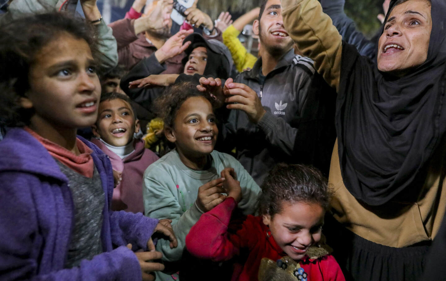 People celebrate along a street at Deir el-Balah in the central Gaza Strip, on January 15, 2025, as news spread that a ceasefire and hostage release deal had been reached between Israel and Hamas aimed at ending more than 15 months of war in the Palestinian territory.