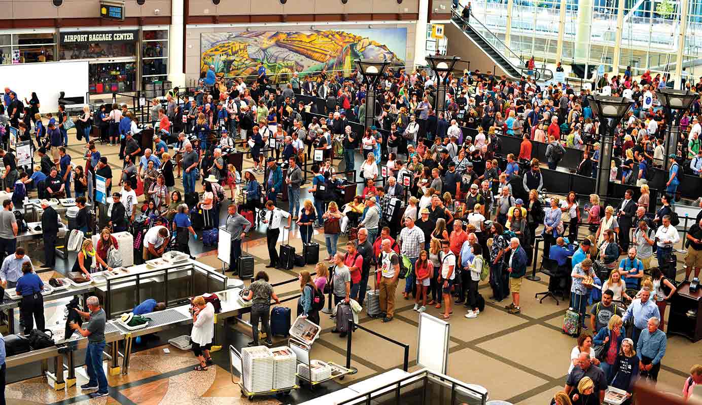 Passengers line up for TSA security screenings at Denver International Airport.