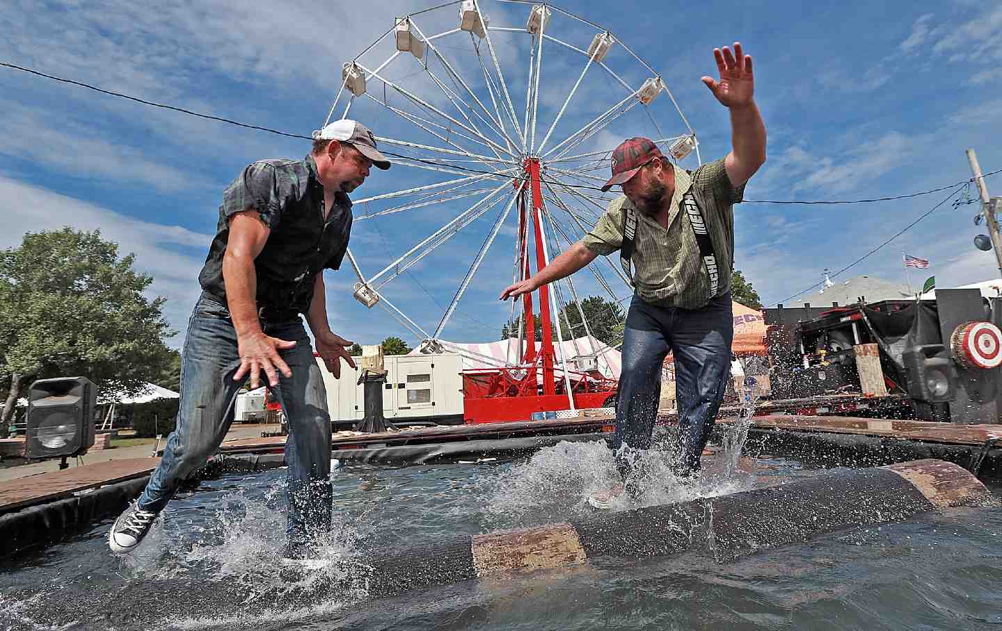 Contestants log roll the Paul Bunyan Lumber Jack Show from Nova Scotia at the Marshfield Fair on August 23, 2019, in Marshfield, Massachusetts.